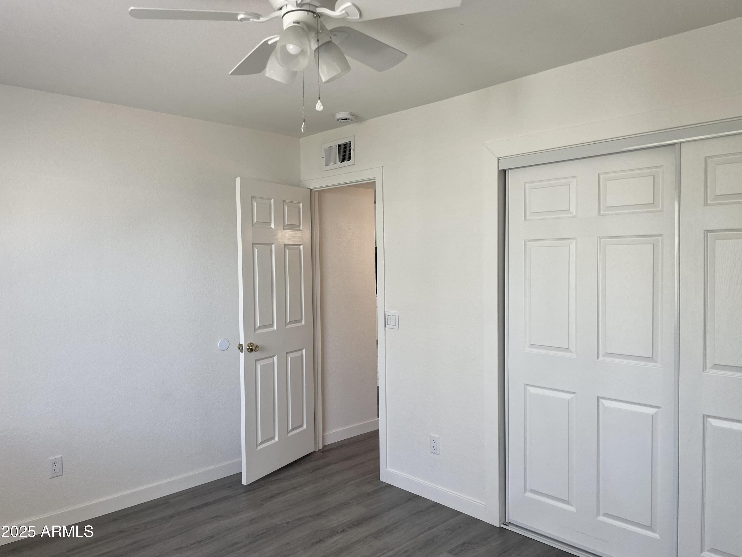 143 South Mountain Road Apache Junction, AZ 85120 - Photo 18 of 38 an empty room with wooden floor closet and windows