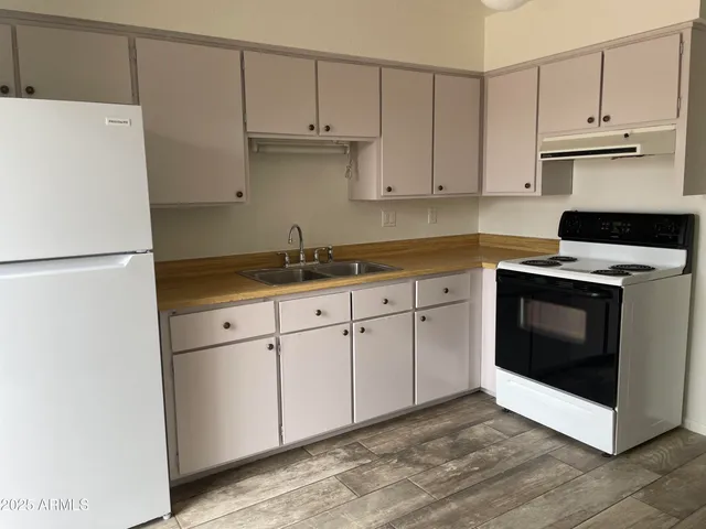 a kitchen with cabinets stainless steel appliances and a sink