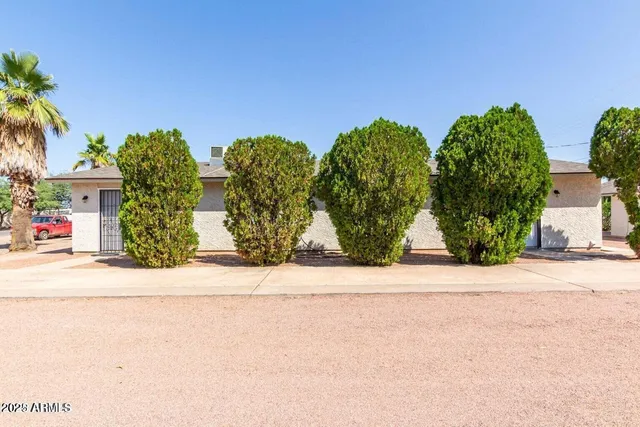 front view of house with potted plants