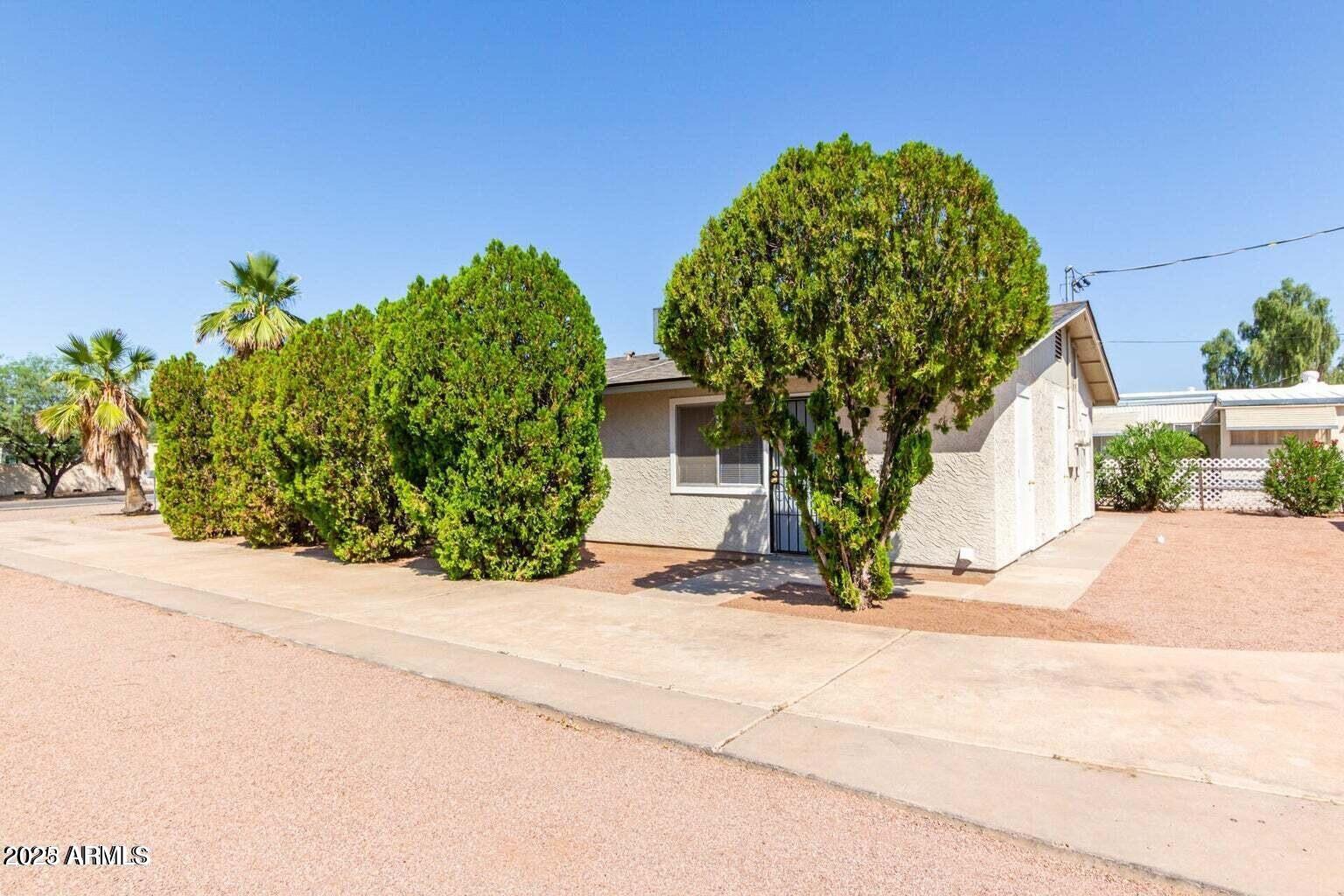 143 South Mountain Road Apache Junction, AZ 85120 - Photo 6 of 38 a front view of a house with garden