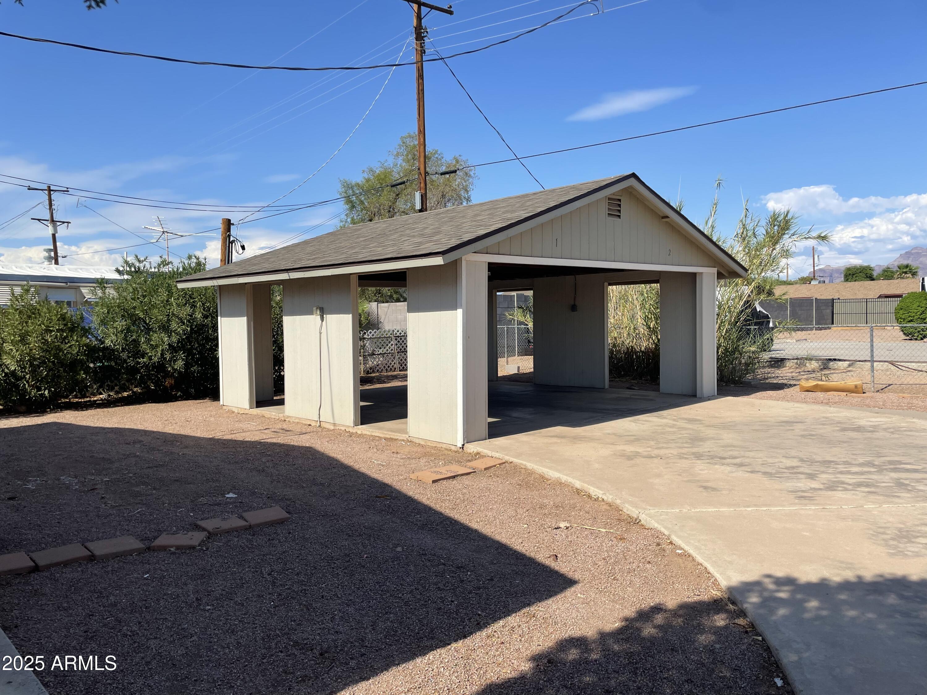 143 South Mountain Road Apache Junction, AZ 85120 - Photo 7 of 38 a front view of a house with a yard