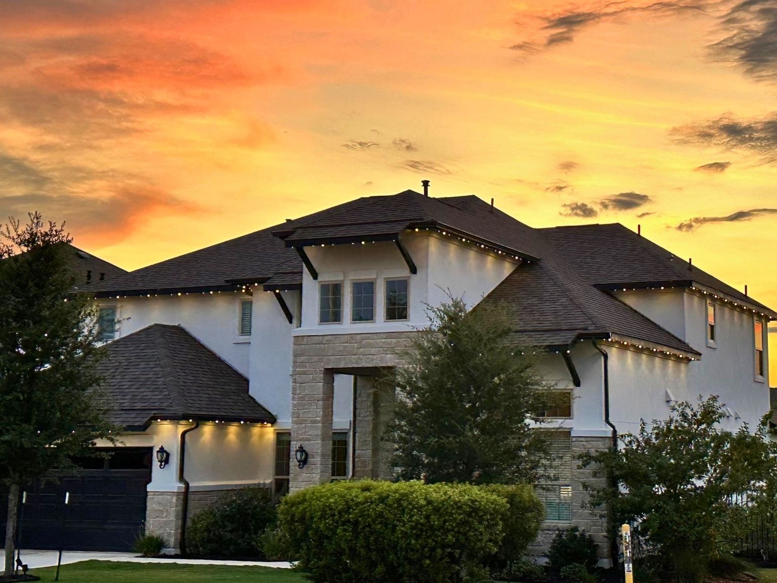4705 Modena Bay Bend Leander, TX 78641 - Photo 1 of 40 View of front of house with stone siding, stucco siding, a shingled roof, and an attached garage