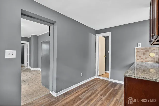 a view of a room with wooden floor and cabinet