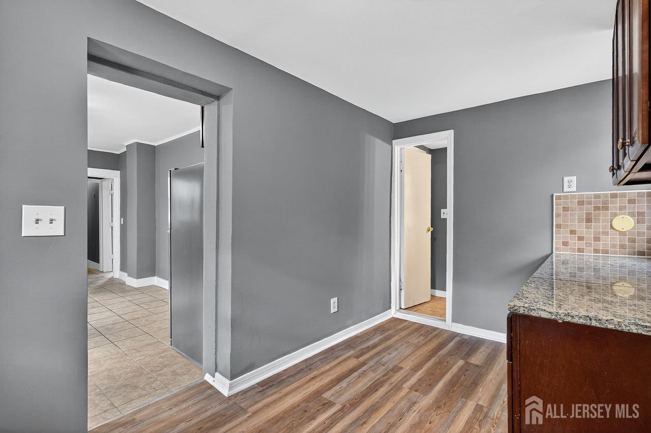 309-311 Pulaski Street Dunellen, NJ 08812 - Photo 12 of 24 a view of a room with wooden floor and cabinet
