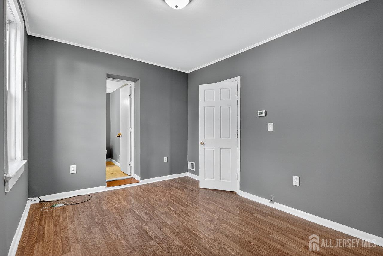 309-311 Pulaski Street Dunellen, NJ 08812 - Photo 14 of 24 a view of a room with wooden floor