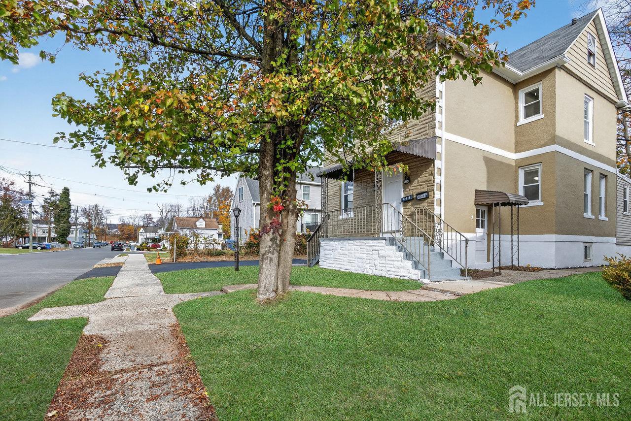 309-311 Pulaski Street Dunellen, NJ 08812 - Photo 2 of 24 a front view of a house with a yard