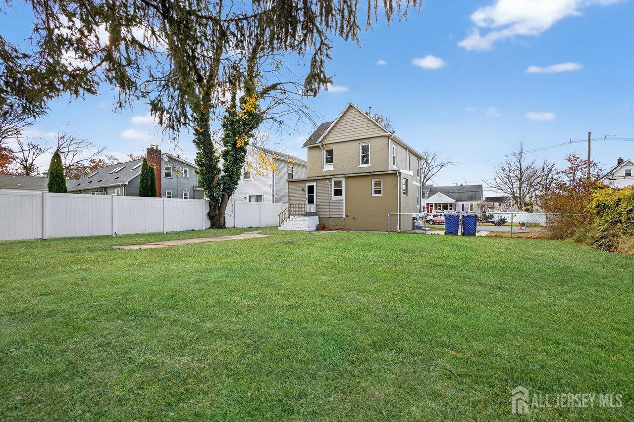 309-311 Pulaski Street Dunellen, NJ 08812 - Photo 22 of 24 a front view of a house with garden