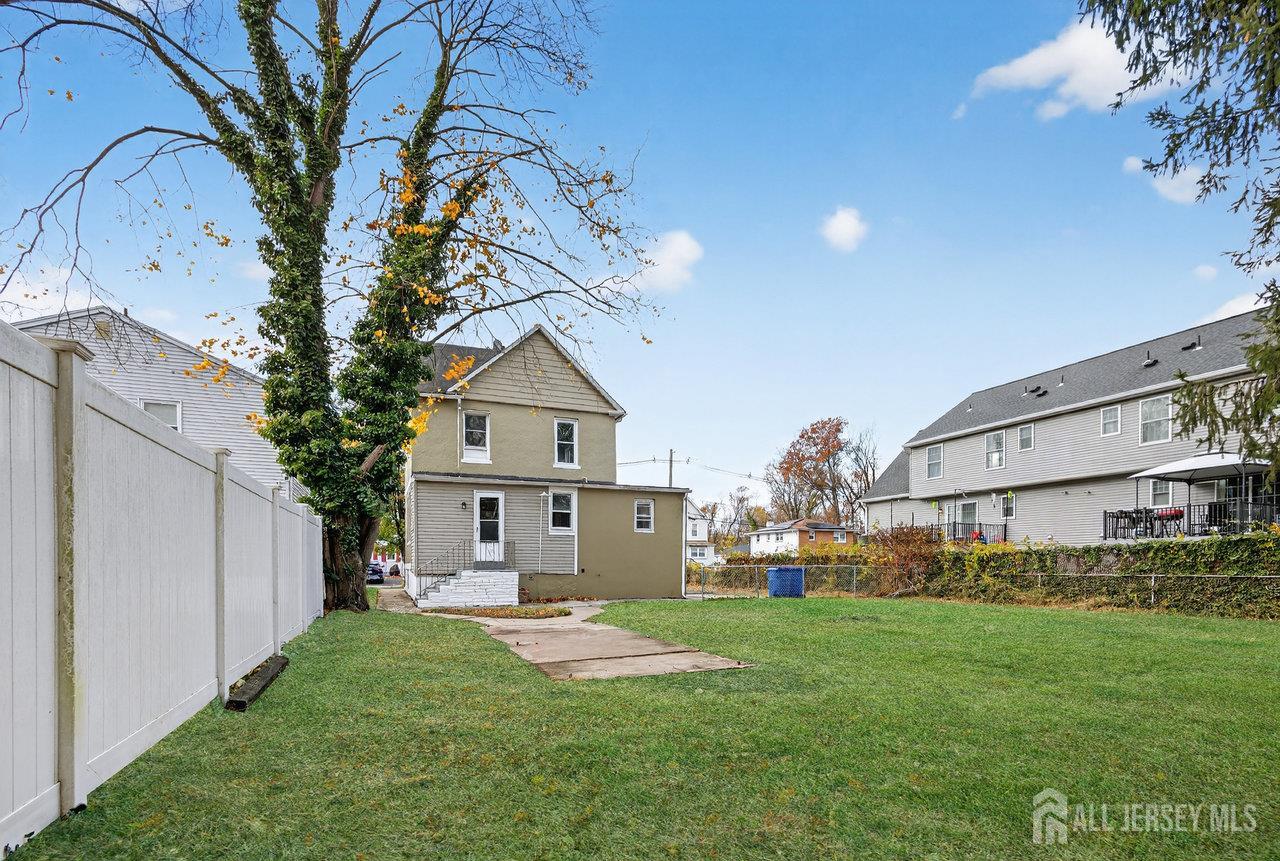 309-311 Pulaski Street Dunellen, NJ 08812 - Photo 23 of 24 a front view of a house with a yard and trees