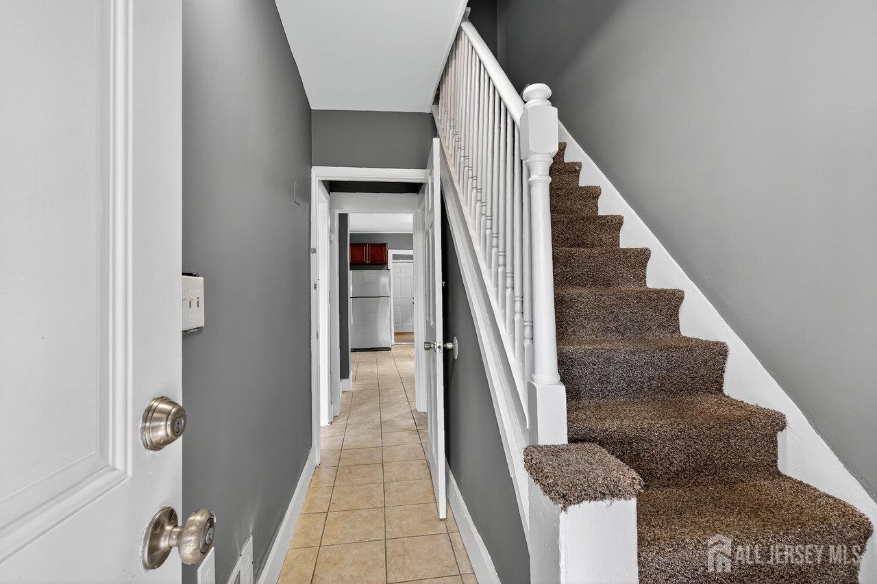309-311 Pulaski Street Dunellen, NJ 08812 - Photo 4 of 24 a view of entryway and hall with wooden floor