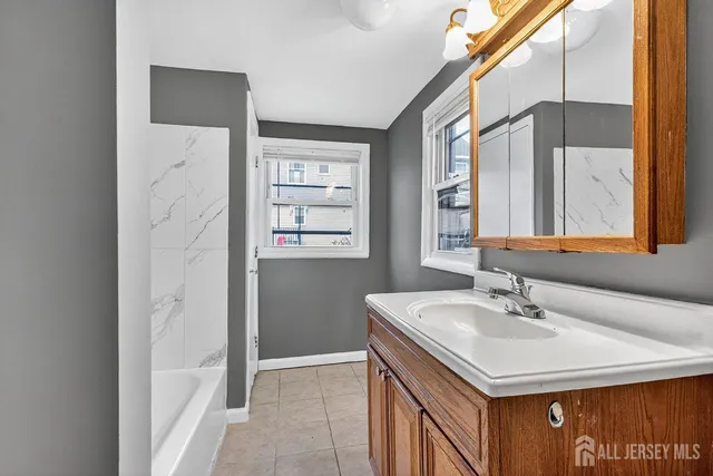 a bathroom with a sink a vanity and a mirror