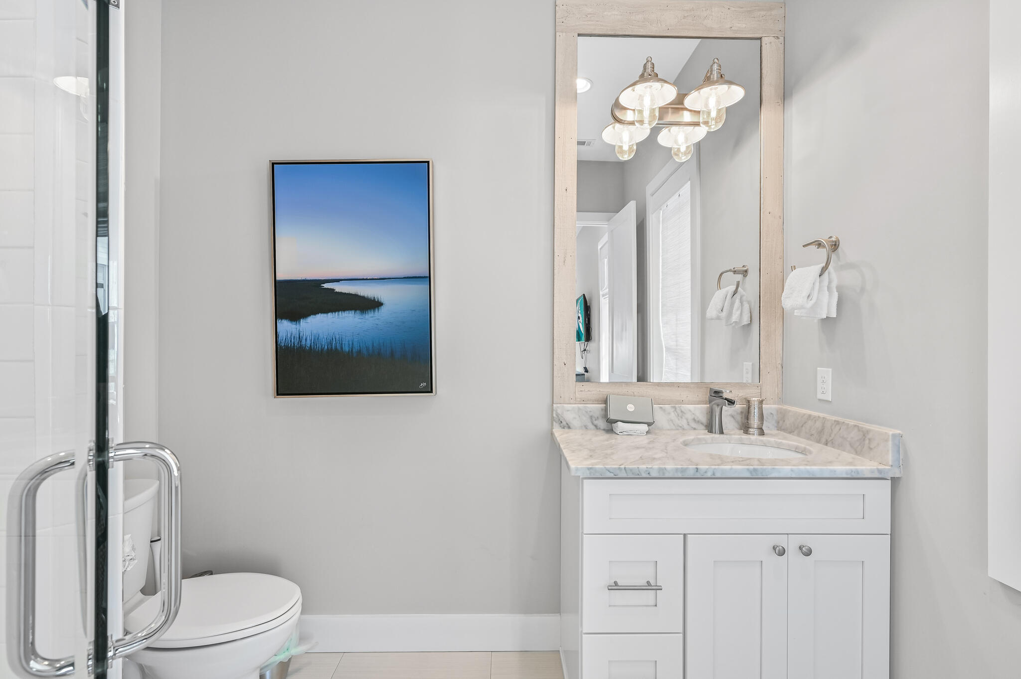 401 Blue Mountain Road Santa Rosa Beach, FL 32459 - Photo 40 of 60 a bathroom with a granite countertop sink a toilet and a mirror