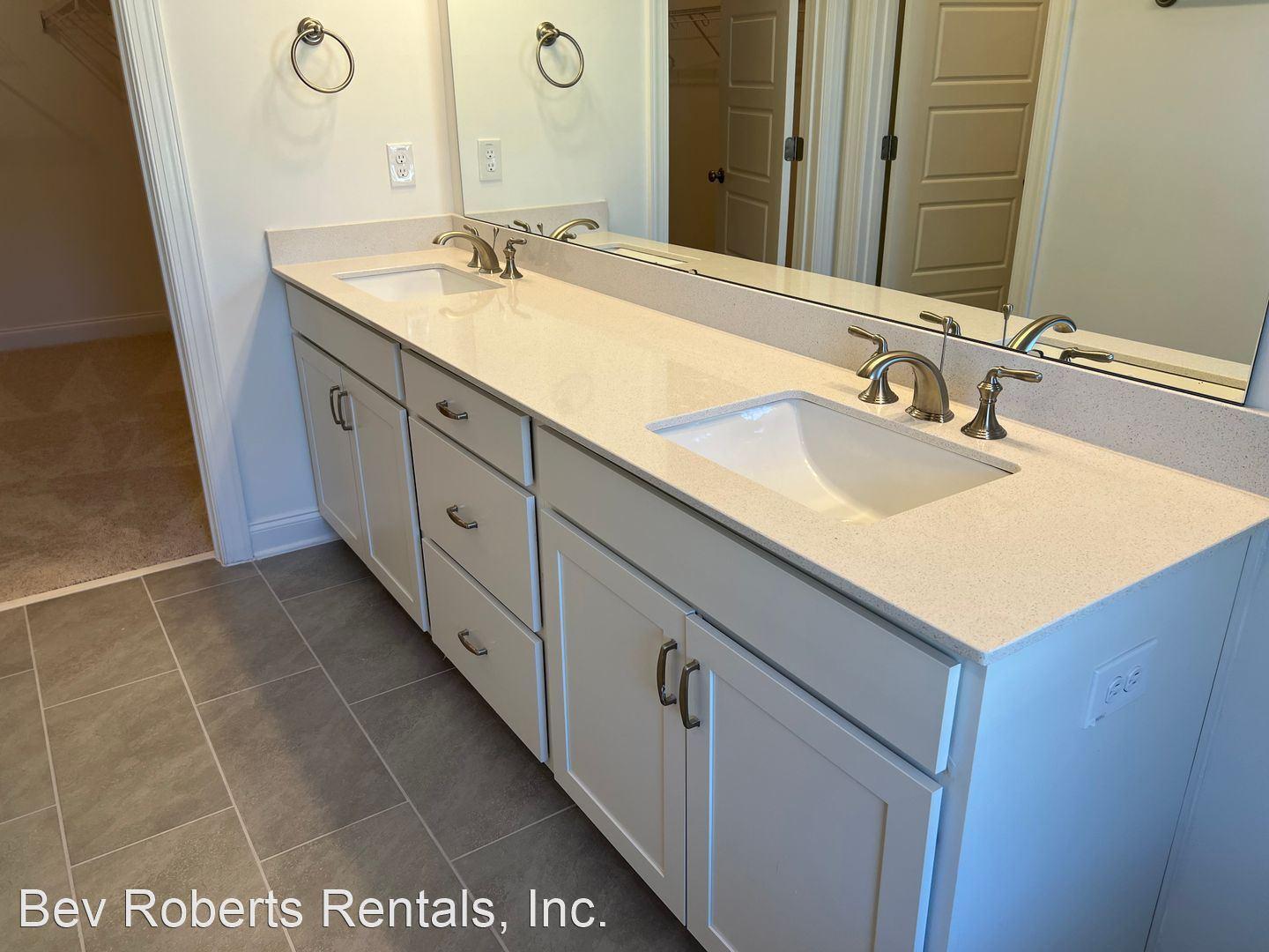 2104 Stegemann Street Apex, NC 27502 - Photo 13 of 29 a bathroom with a sink double vanity and a mirror
