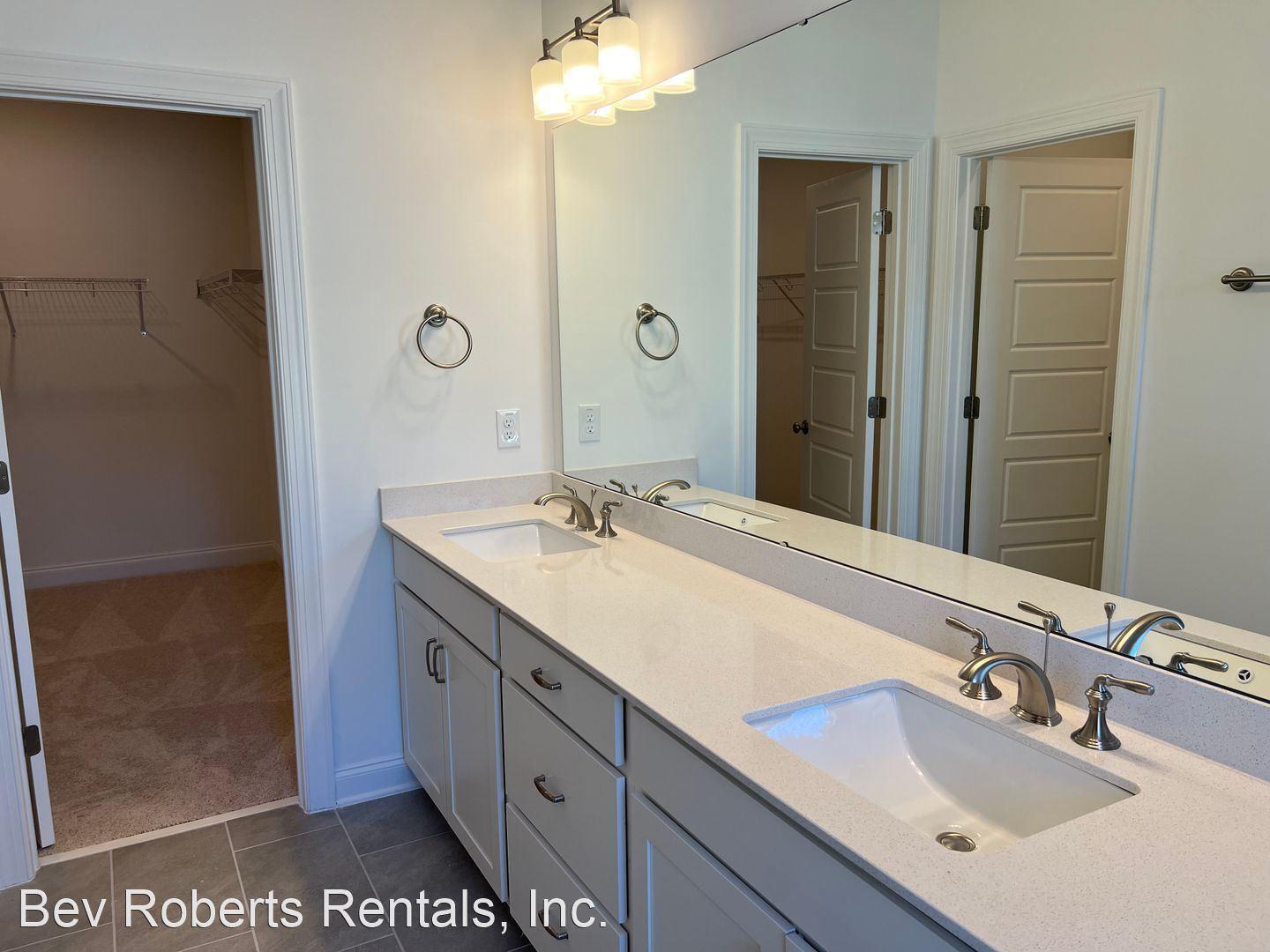 2104 Stegemann Street Apex, NC 27502 - Photo 14 of 29 a bathroom with a sink double vanity and a mirror