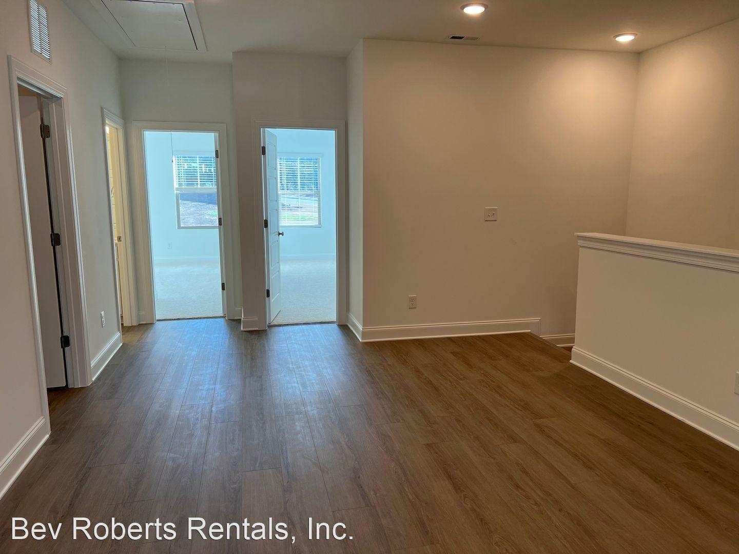 2104 Stegemann Street Apex, NC 27502 - Photo 15 of 29 an empty room with wooden floor and windows