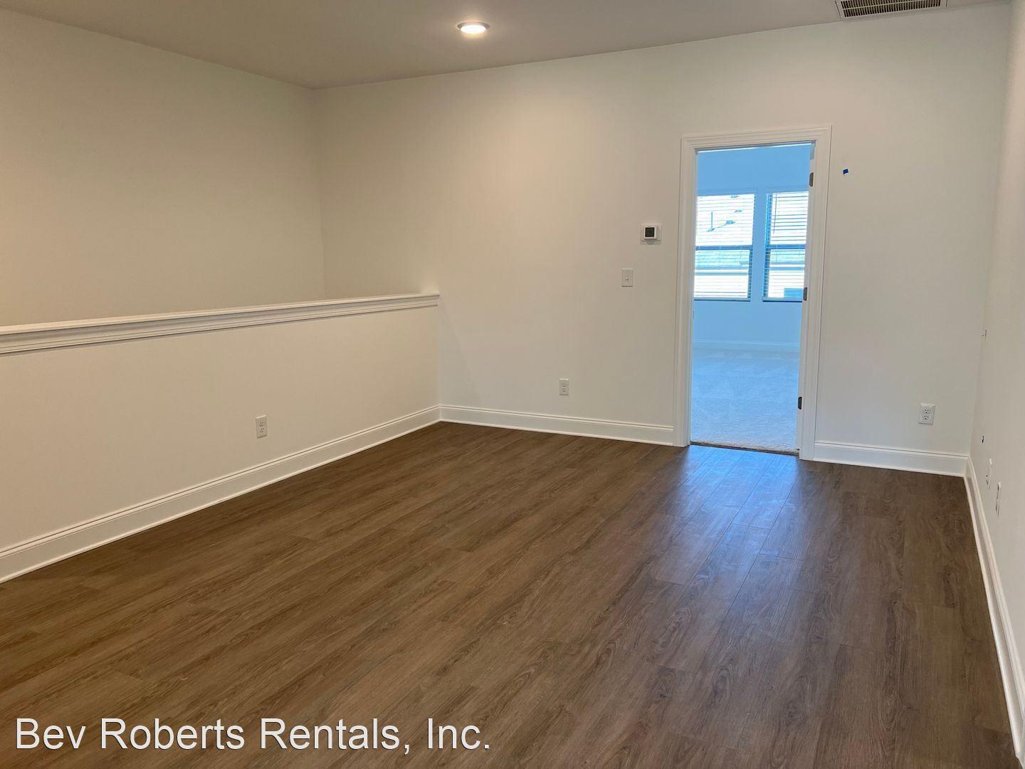 2104 Stegemann Street Apex, NC 27502 - Photo 16 of 29 an empty room with wooden floor and cabinet