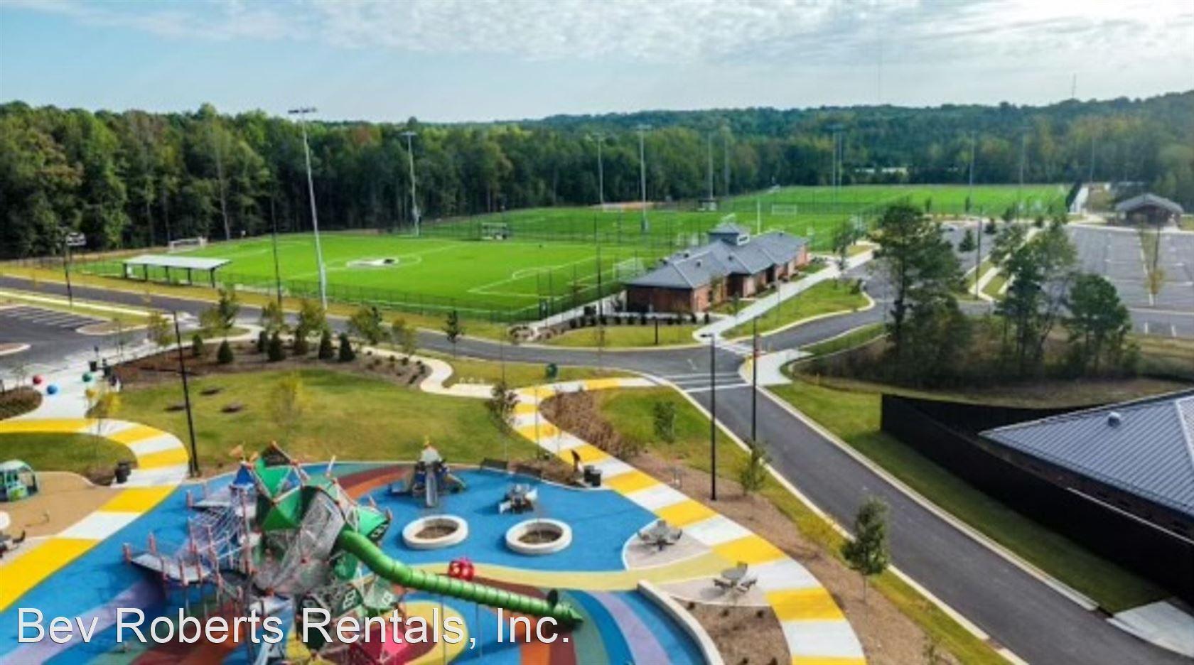 2104 Stegemann Street Apex, NC 27502 - Photo 25 of 29 a view of a swimming pool with a yard and outdoor seating