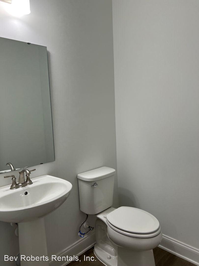 2104 Stegemann Street Apex, NC 27502 - Photo 3 of 29 a white toilet sitting next to a bathroom sink