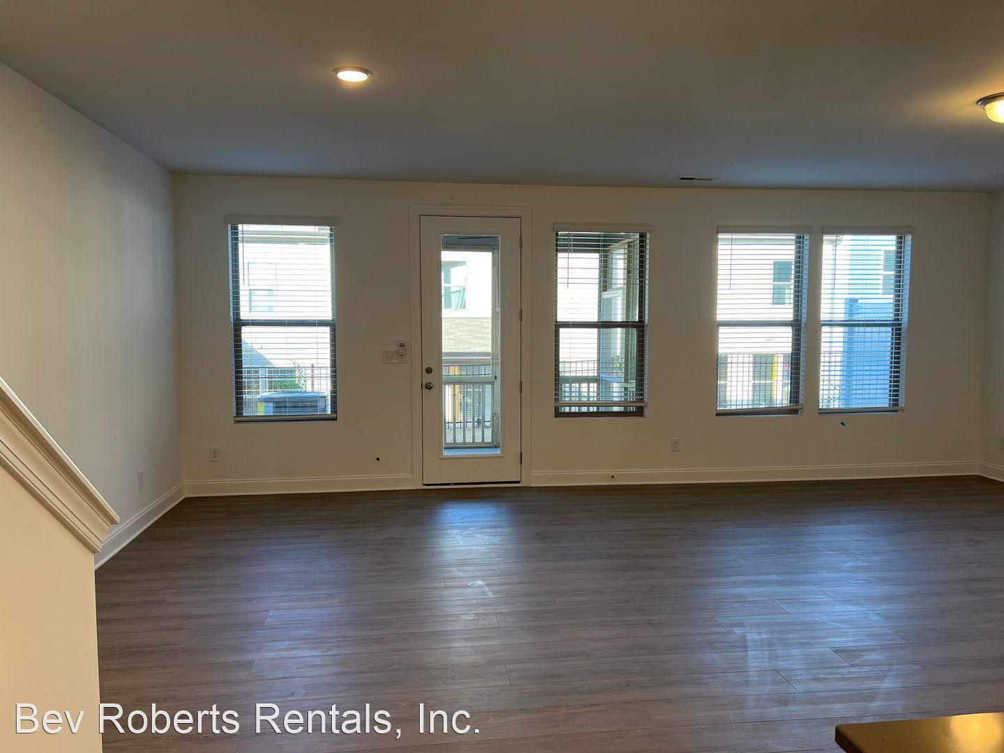 2104 Stegemann Street Apex, NC 27502 - Photo 7 of 29 a view of an empty room with wooden floor and a window