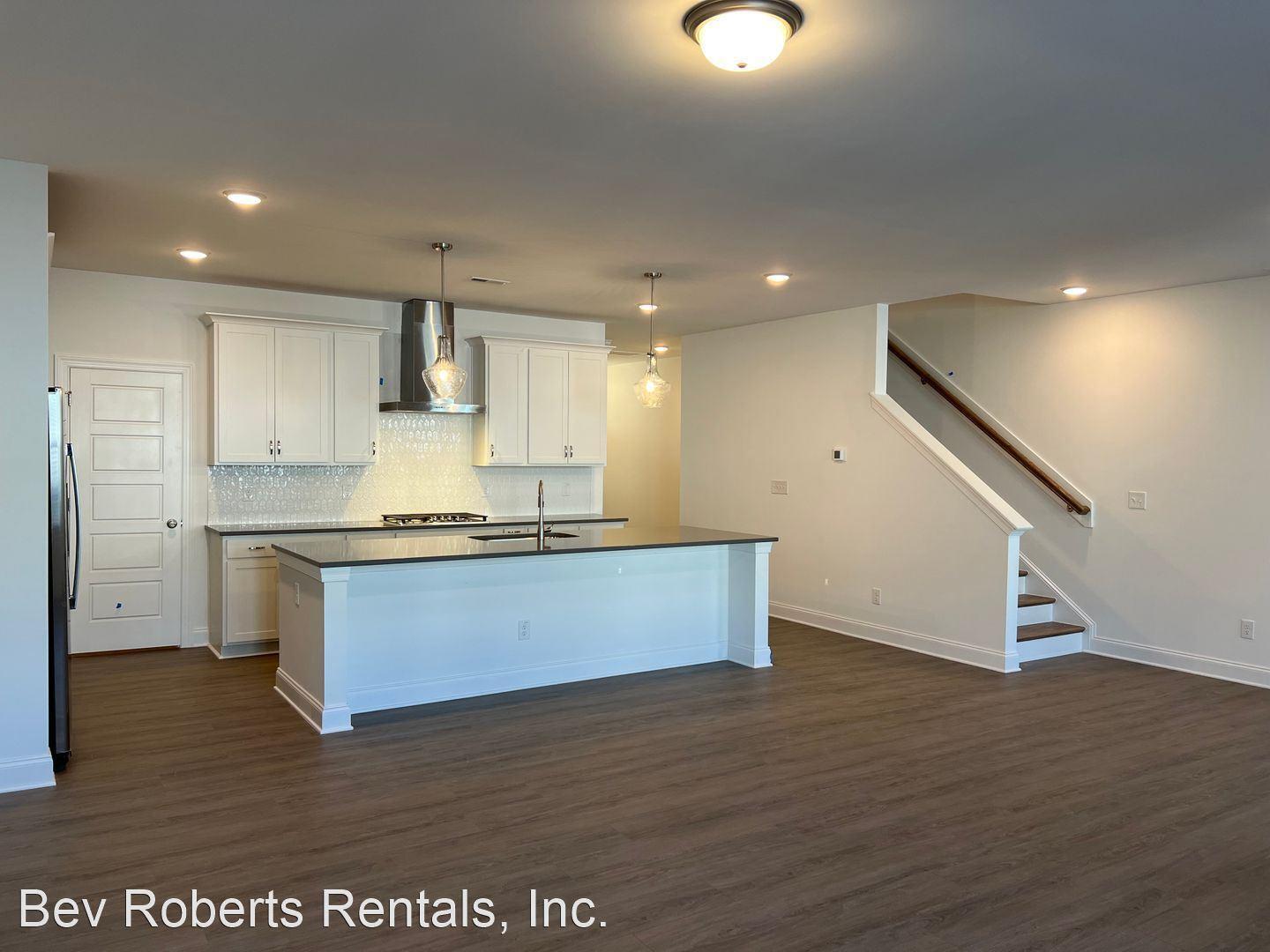 2104 Stegemann Street Apex, NC 27502 - Photo 8 of 29 a large kitchen with stainless steel appliances granite countertop a large counter top a sink and a refrigerator