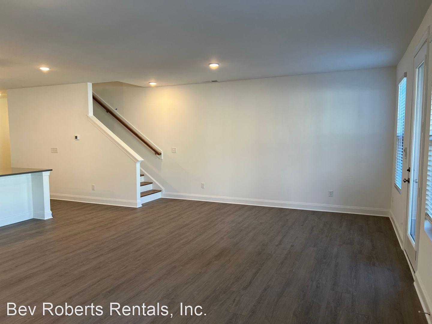 2104 Stegemann Street Apex, NC 27502 - Photo 9 of 29 a view of an empty room with wooden floor and stairs