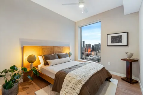 a bedroom with a bed and wooden floor