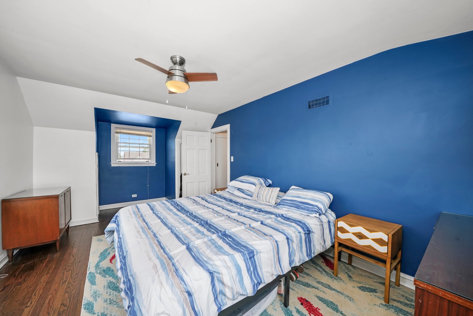 7801 West Victoria Street Chicago, IL 60631 - Photo 15 of 30 a bedroom with a bed a dresser and wooden floor