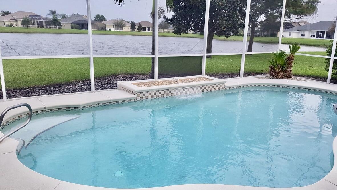 4751 Chardonnay Drive Rockledge, FL 32955 - Photo 2 of 25 a view of a swimming pool with a patio
