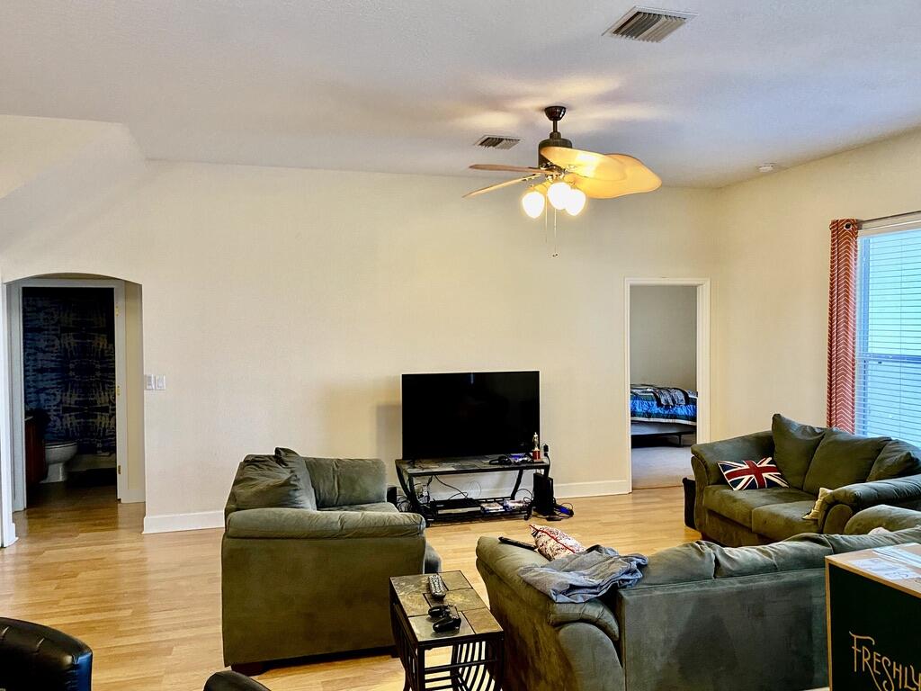 4751 Chardonnay Drive Rockledge, FL 32955 - Photo 7 of 25 a living room with furniture and a flat screen tv