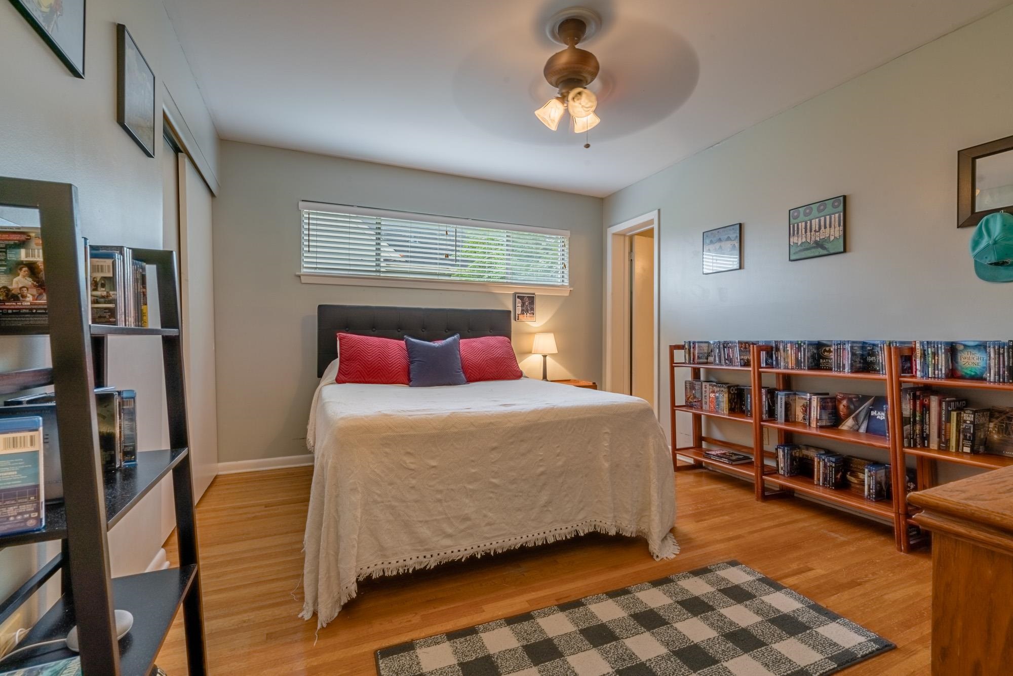 5356 Quince Road Memphis, TN 38119 - Photo 13 of 21 a bedroom with a bed furniture and a book shelf