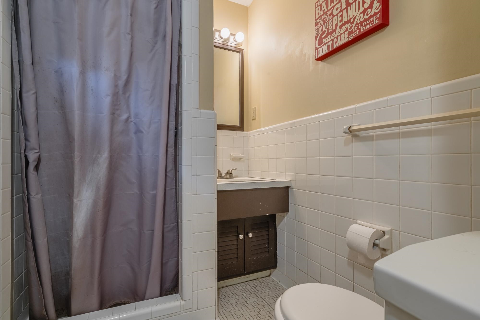5356 Quince Road Memphis, TN 38119 - Photo 14 of 21 a bathroom with a toilet a sink and mirror