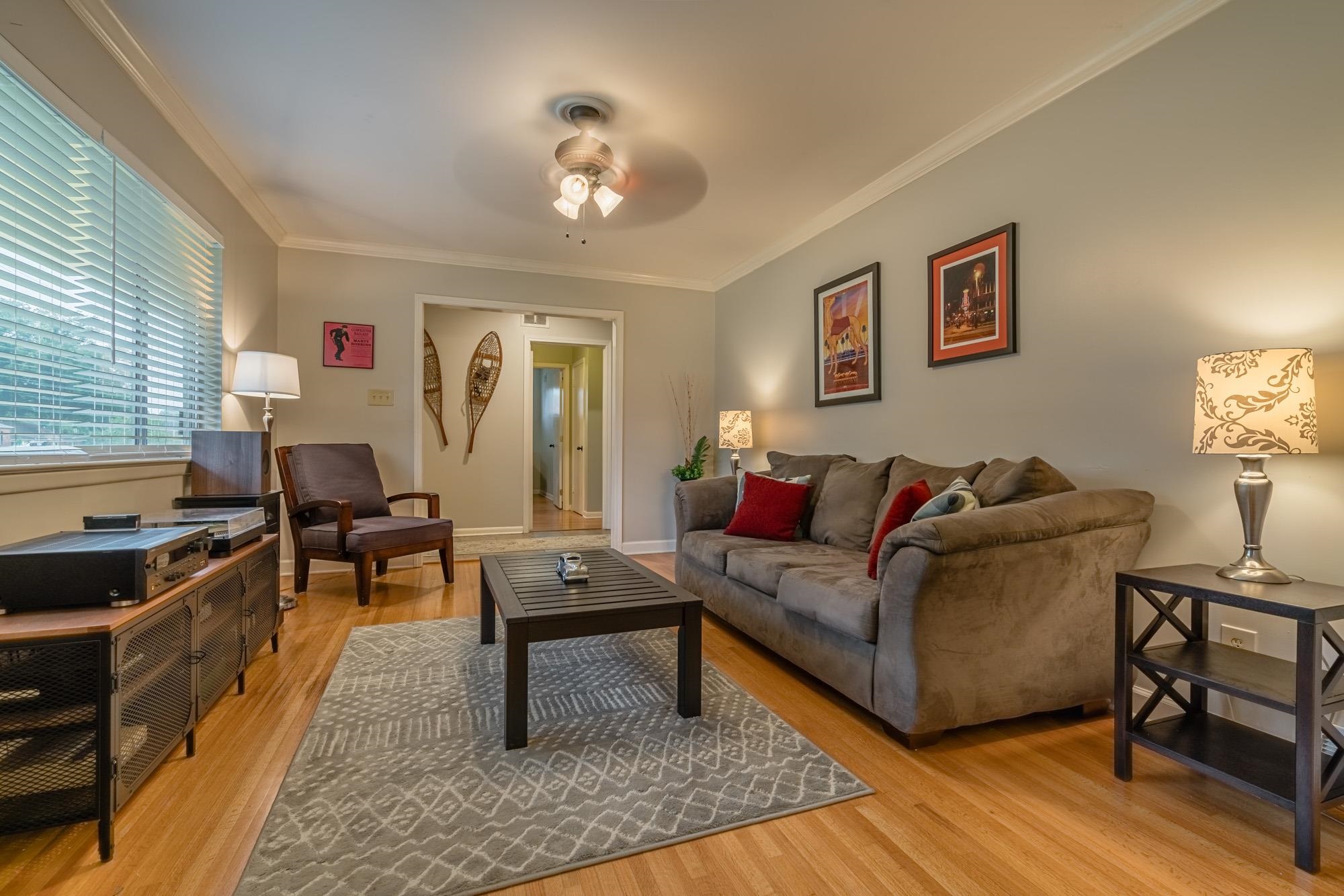 5356 Quince Road Memphis, TN 38119 - Photo 5 of 21 a living room with furniture and a chandelier