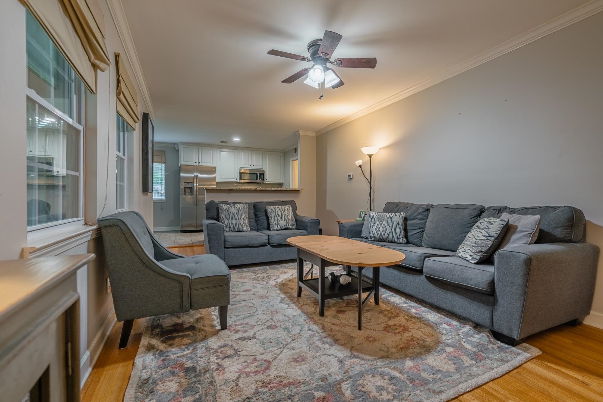 5356 Quince Road Memphis, TN 38119 - Photo 6 of 21 a living room with furniture and a chandelier