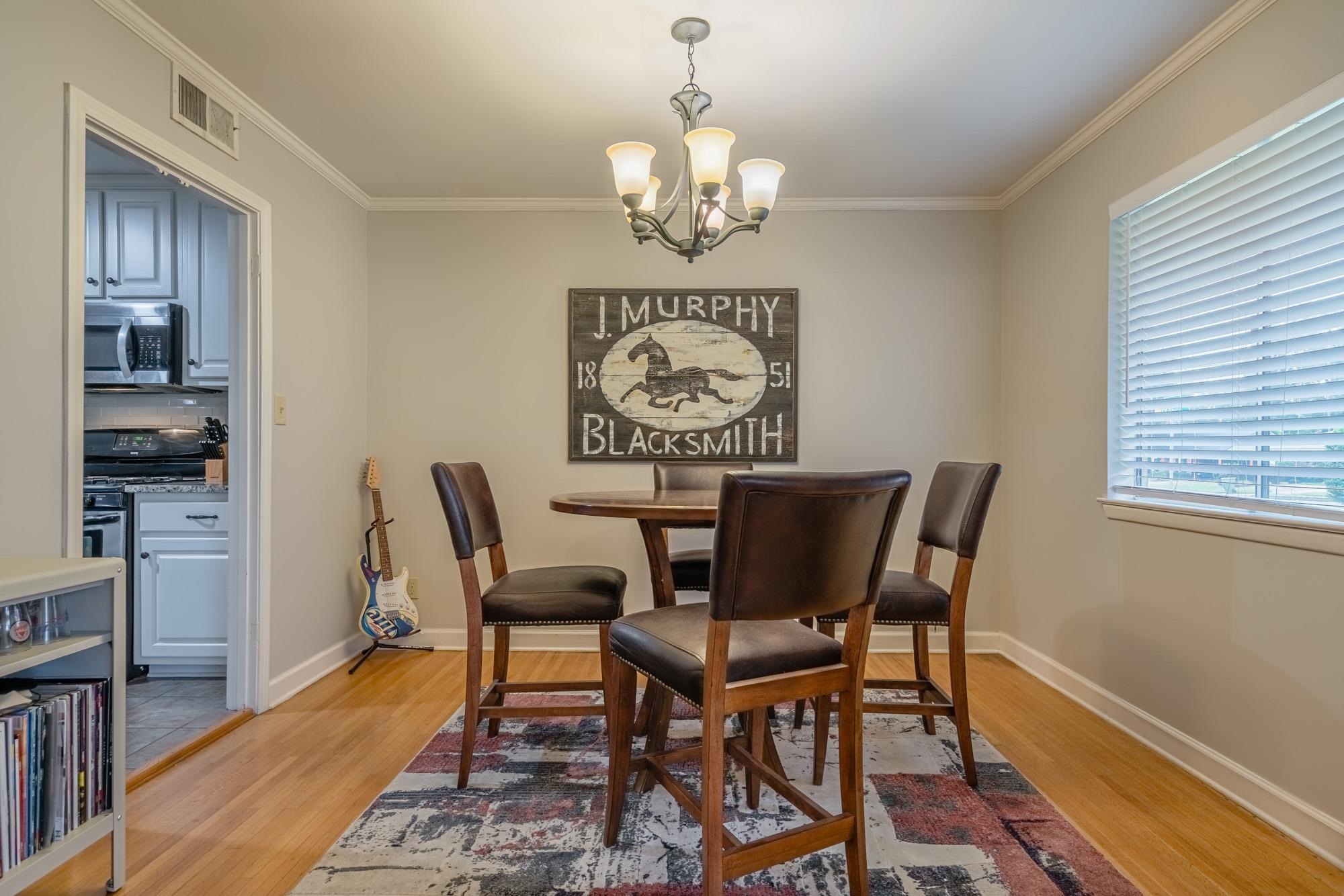 5356 Quince Road Memphis, TN 38119 - Photo 7 of 21 a view of a dining room with furniture wooden floor and a chandelier