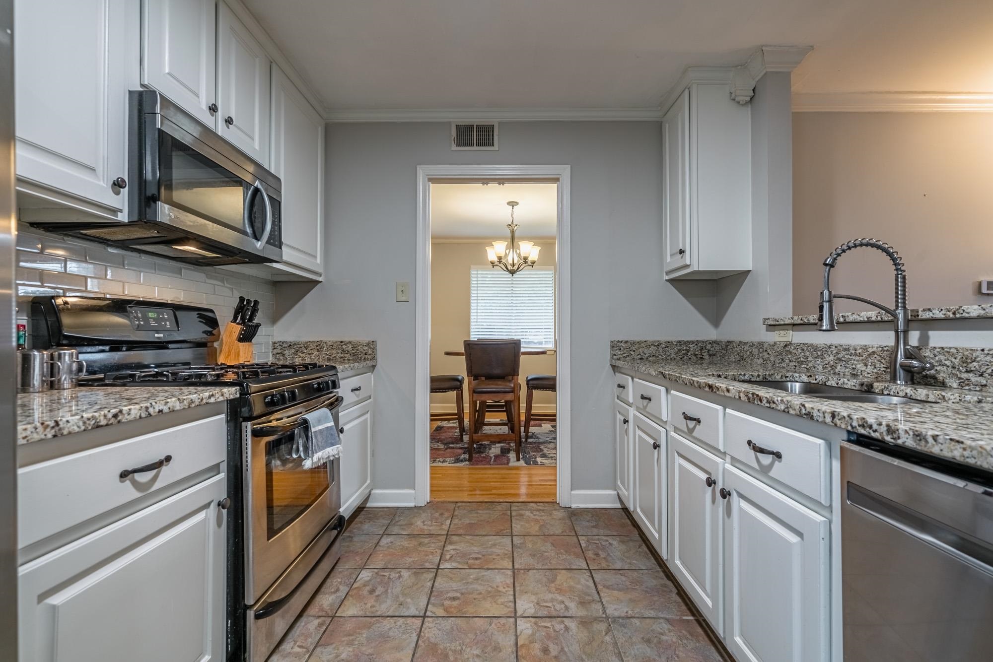 5356 Quince Road Memphis, TN 38119 - Photo 10 of 21 a kitchen with stainless steel appliances granite countertop a stove and a sink