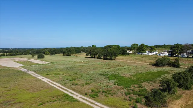 a view of outdoor space with green field and trees