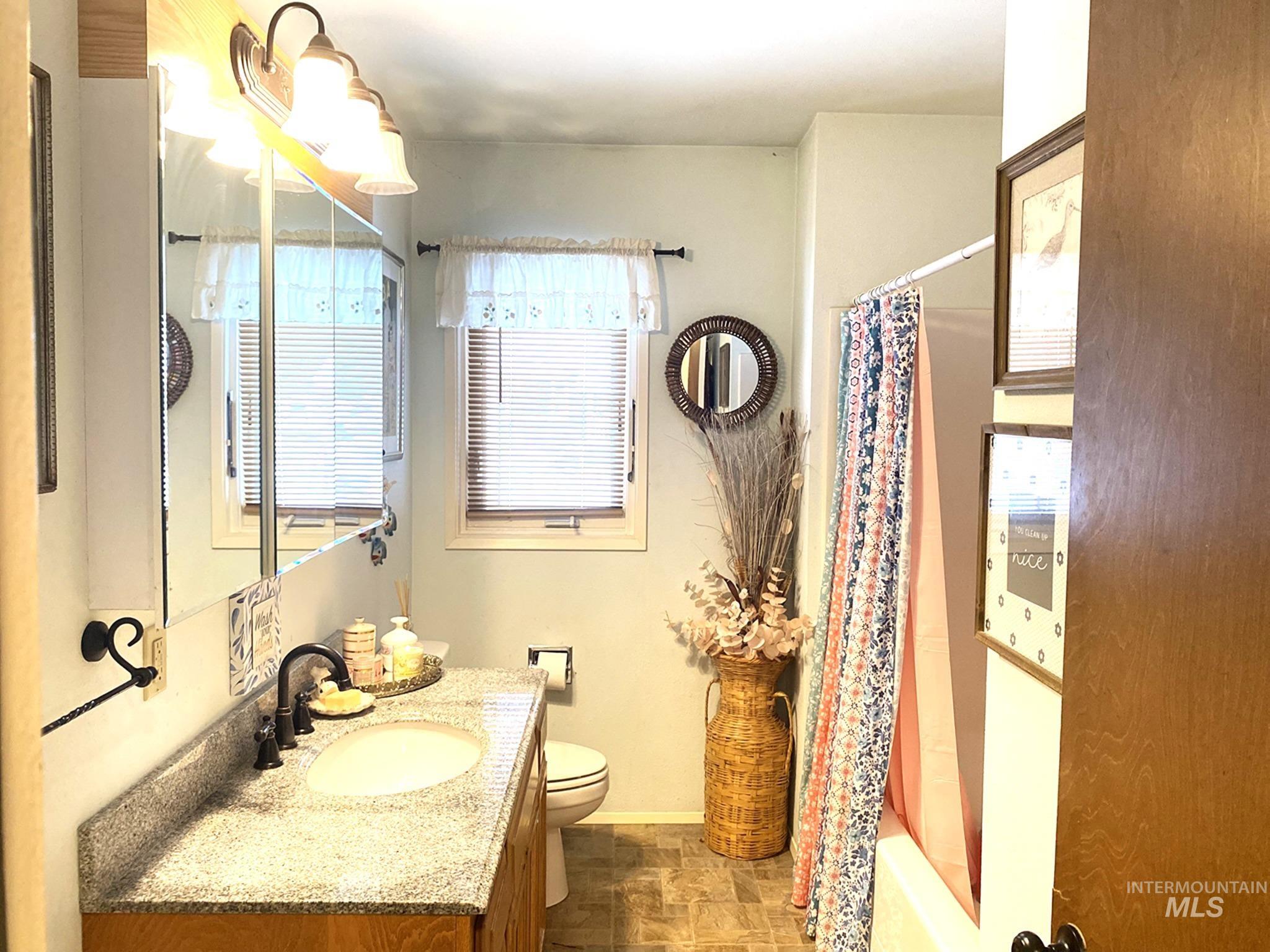 138 Timberline Drive Pierce, ID 83546 - Photo 12 of 28 Full bath with vanity, shower / bath combo with shower curtain, and stone finish floors