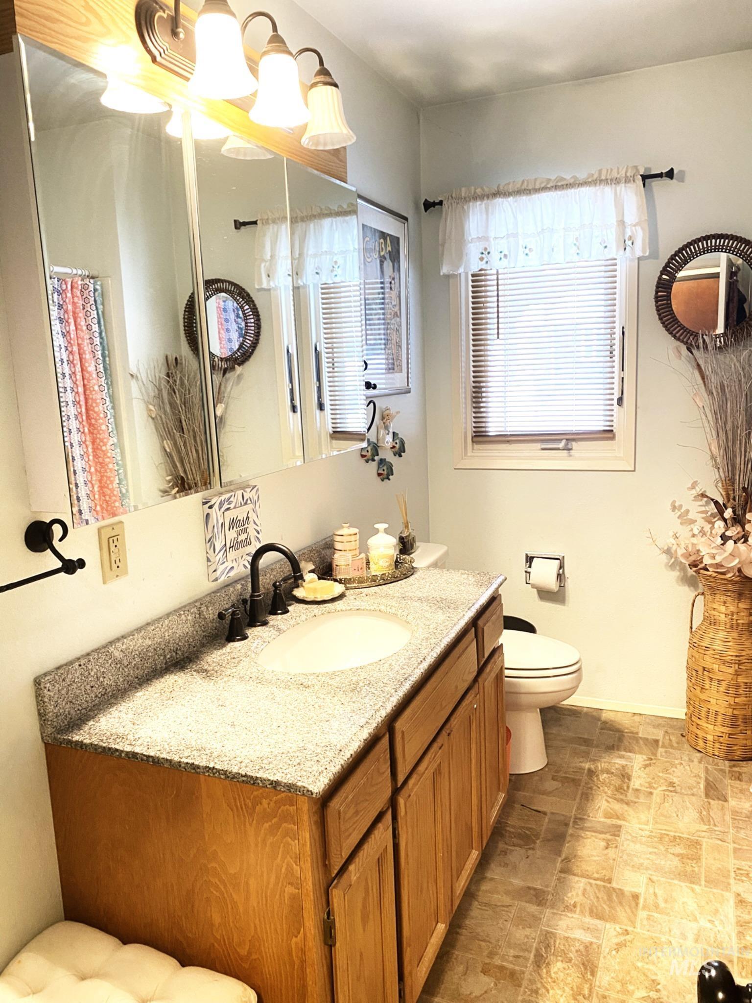 138 Timberline Drive Pierce, ID 83546 - Photo 13 of 28 Full bath with stone finish flooring, vanity, and a shower with curtain