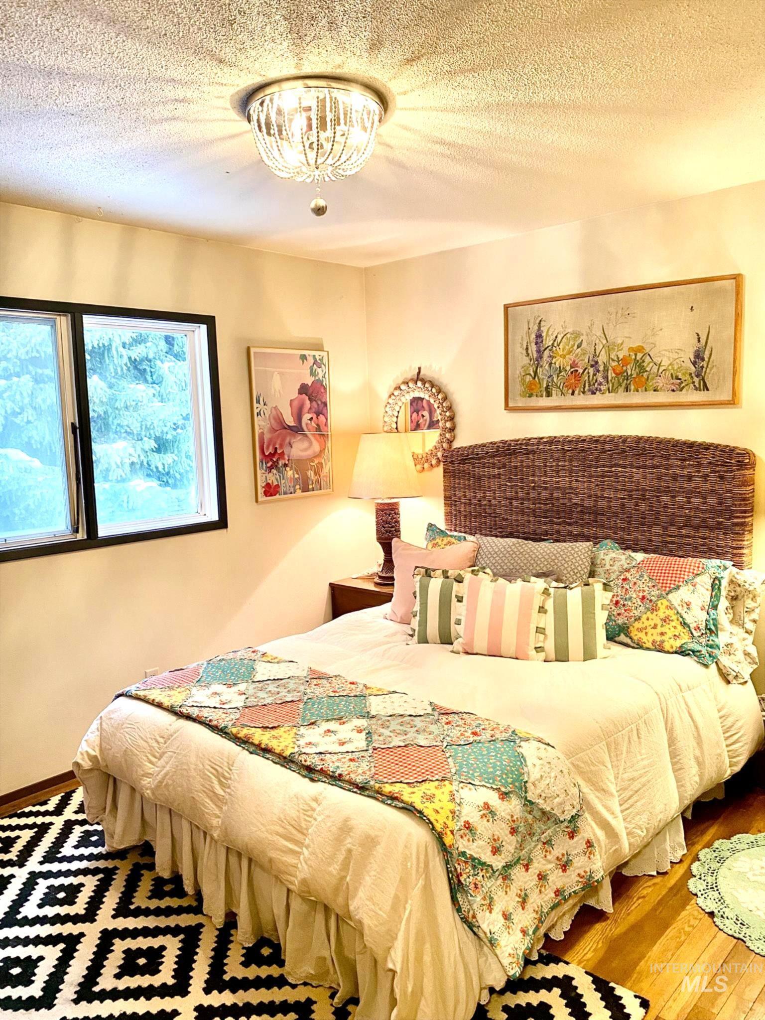 138 Timberline Drive Pierce, ID 83546 - Photo 14 of 28 Bedroom with a textured ceiling and hardwood / wood-style flooring