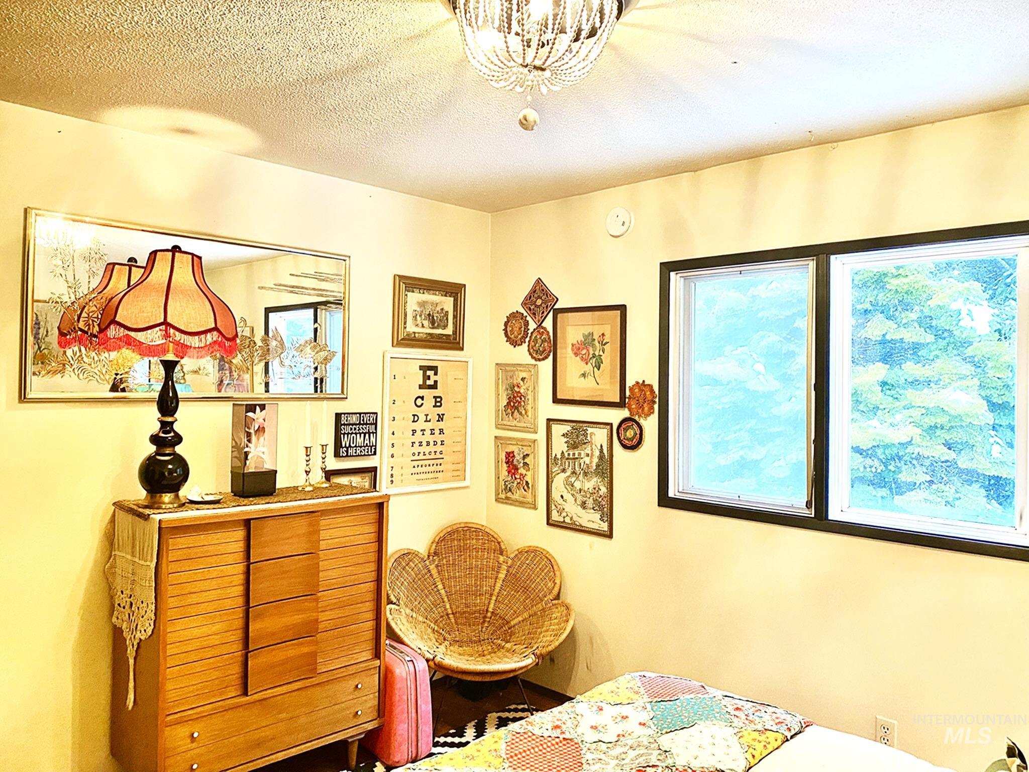 138 Timberline Drive Pierce, ID 83546 - Photo 16 of 28 Bedroom featuring a textured ceiling and a chandelier