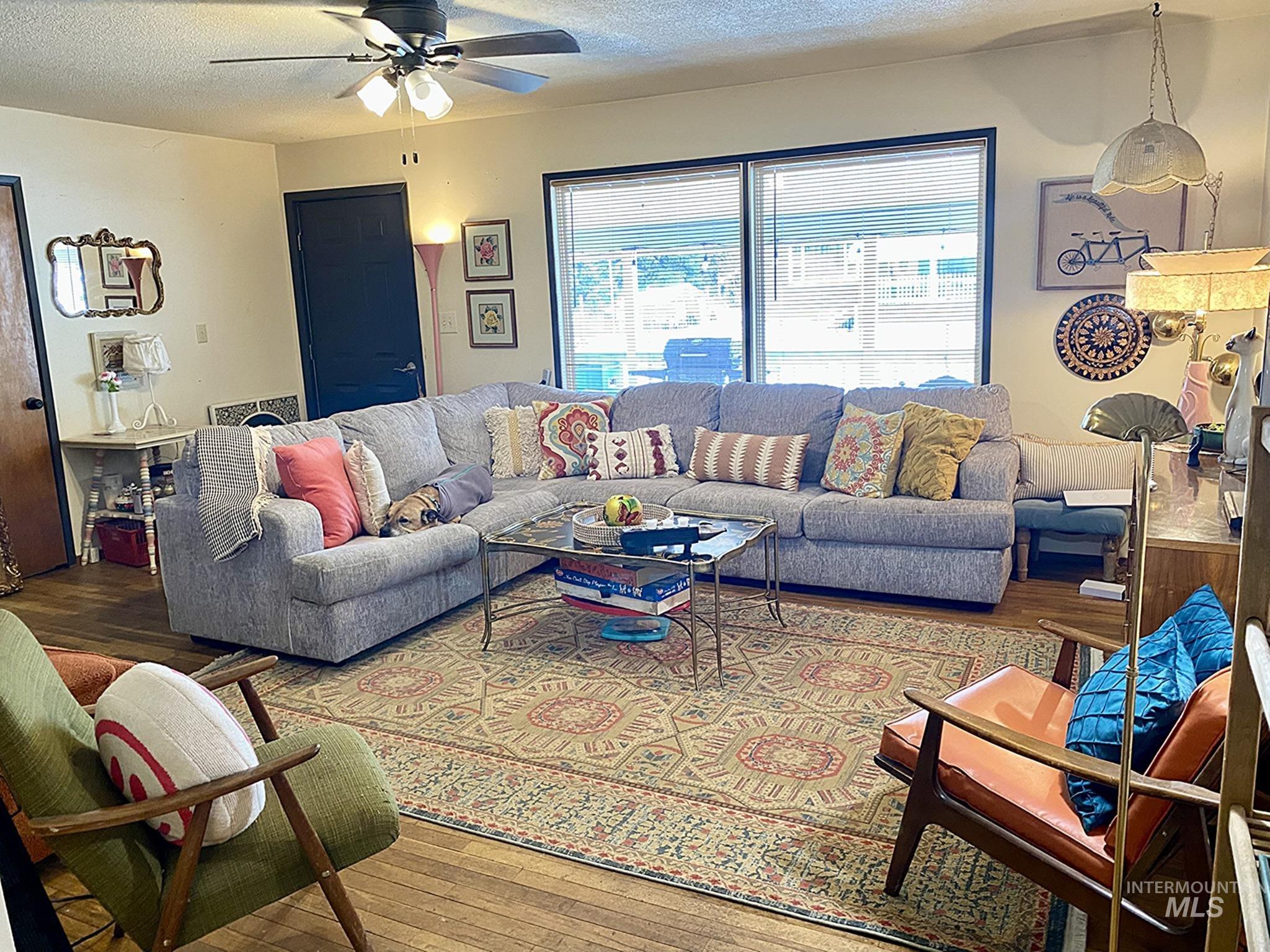 138 Timberline Drive Pierce, ID 83546 - Photo 2 of 28 Living area with wood-type flooring, a textured ceiling, and a ceiling fan