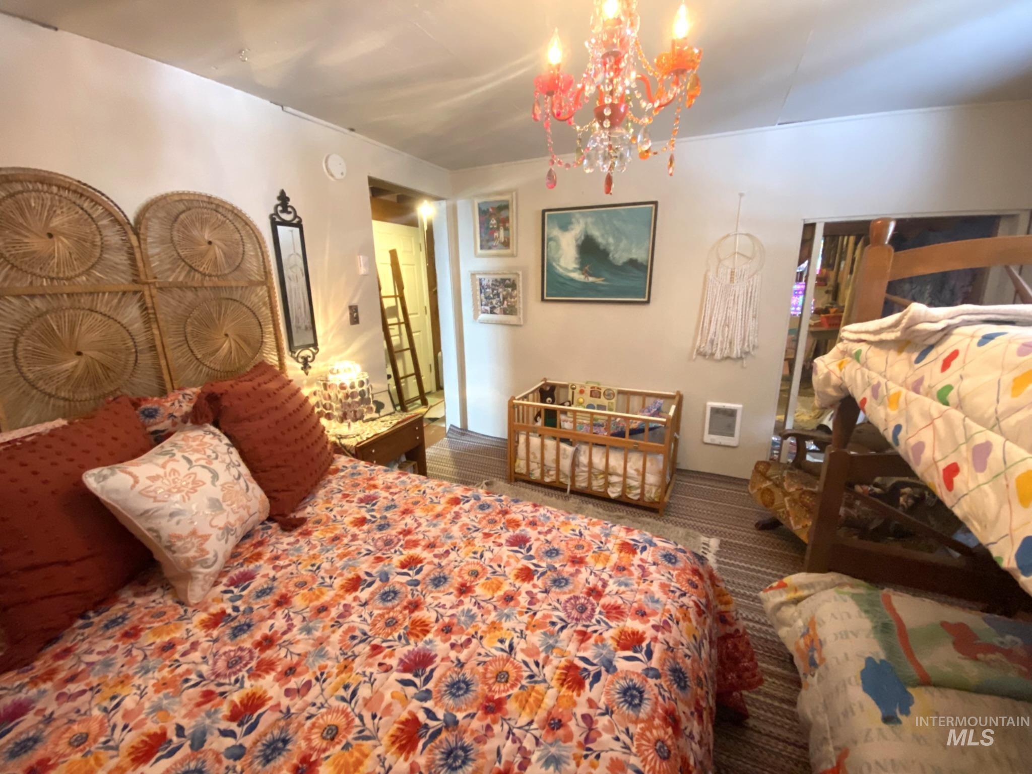 138 Timberline Drive Pierce, ID 83546 - Photo 21 of 28 Bedroom featuring a chandelier