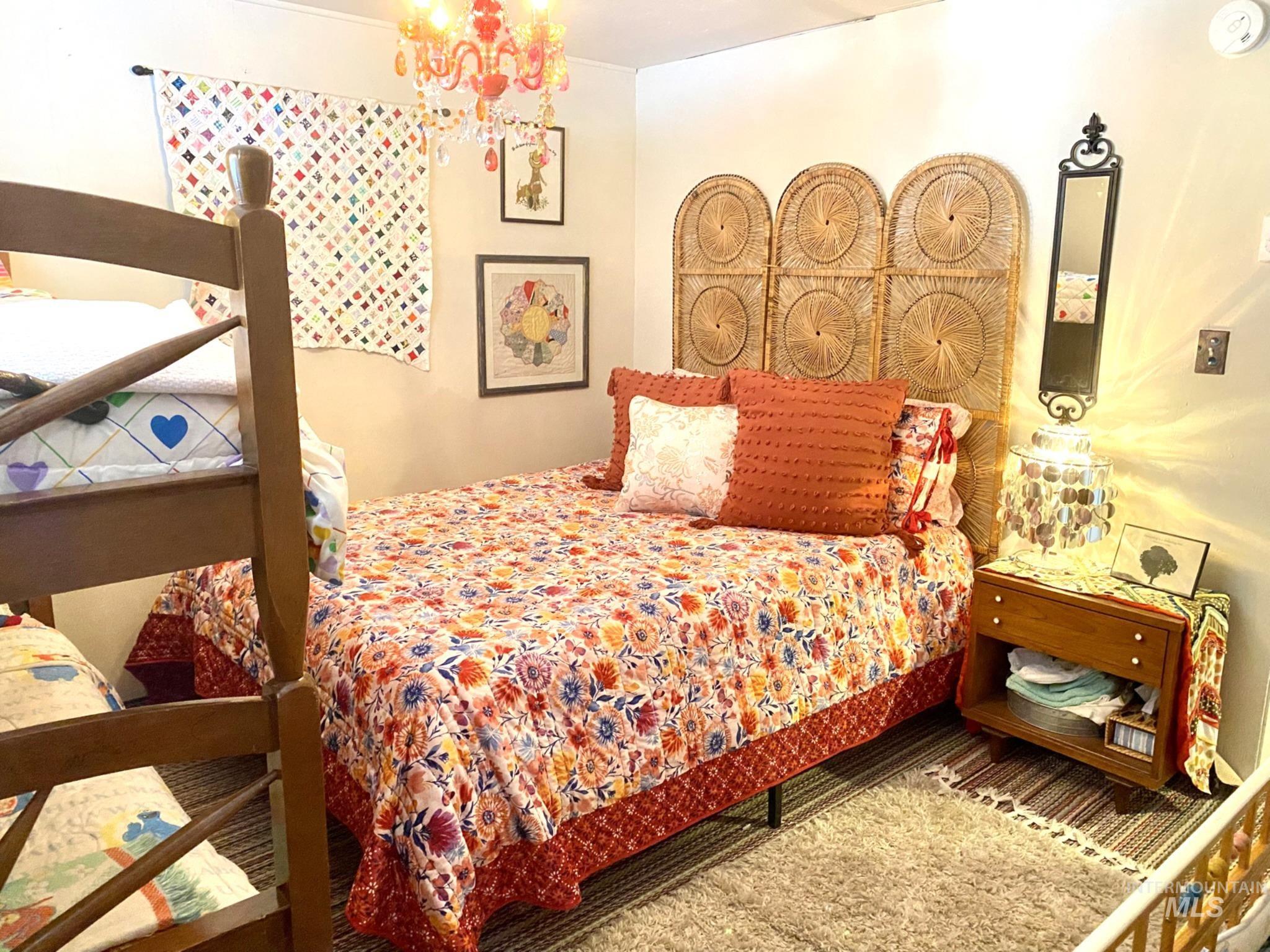 138 Timberline Drive Pierce, ID 83546 - Photo 22 of 28 Bedroom featuring hanging lights and wood finished floors