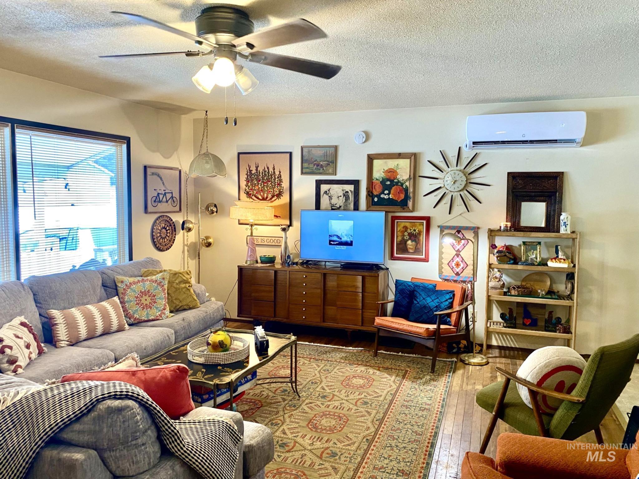 138 Timberline Drive Pierce, ID 83546 - Photo 5 of 28 Living area featuring a textured ceiling, a ceiling fan, and hardwood / wood-style floors