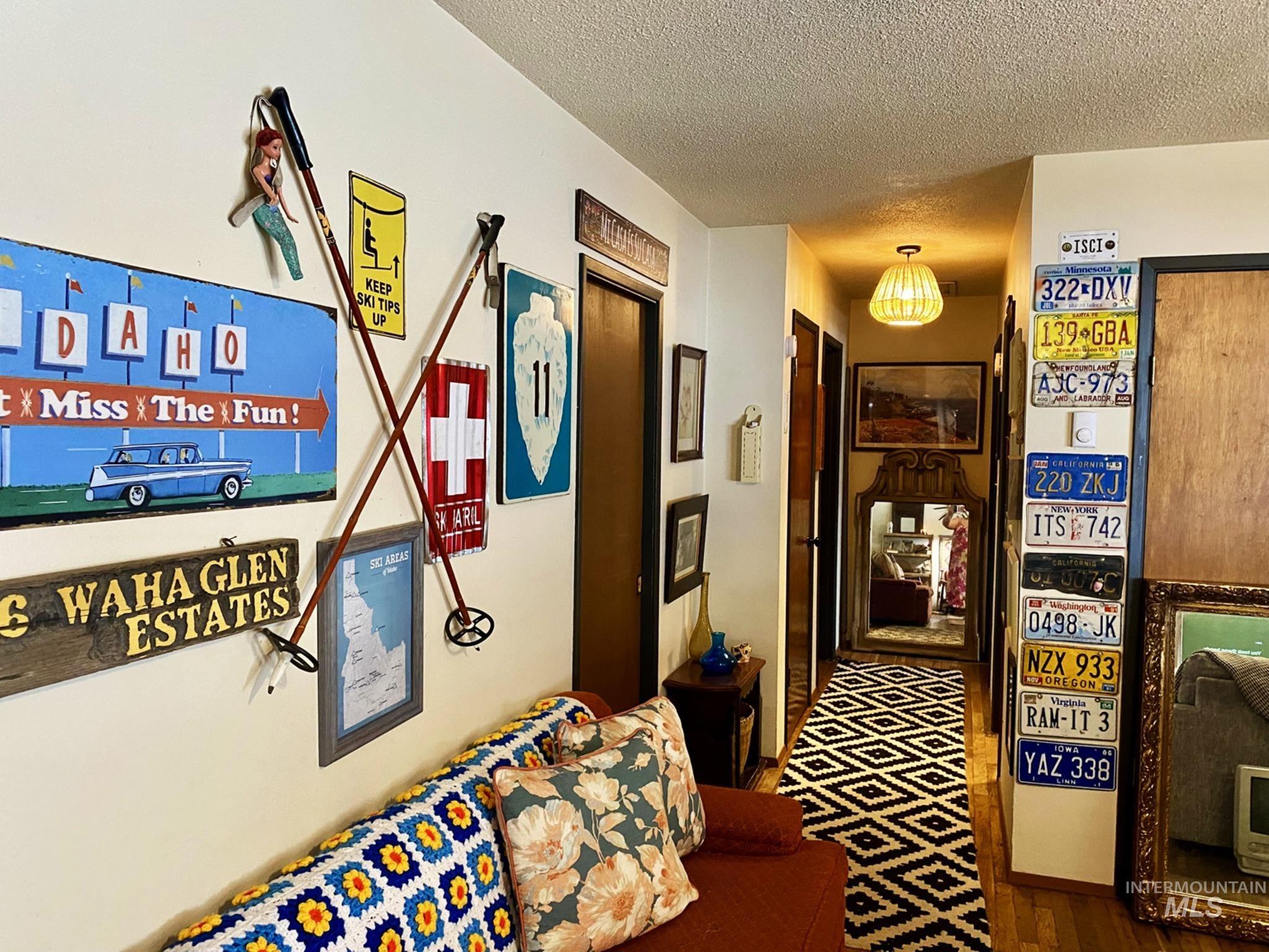 138 Timberline Drive Pierce, ID 83546 - Photo 6 of 28 Hallway featuring a textured ceiling and dark wood-style flooring