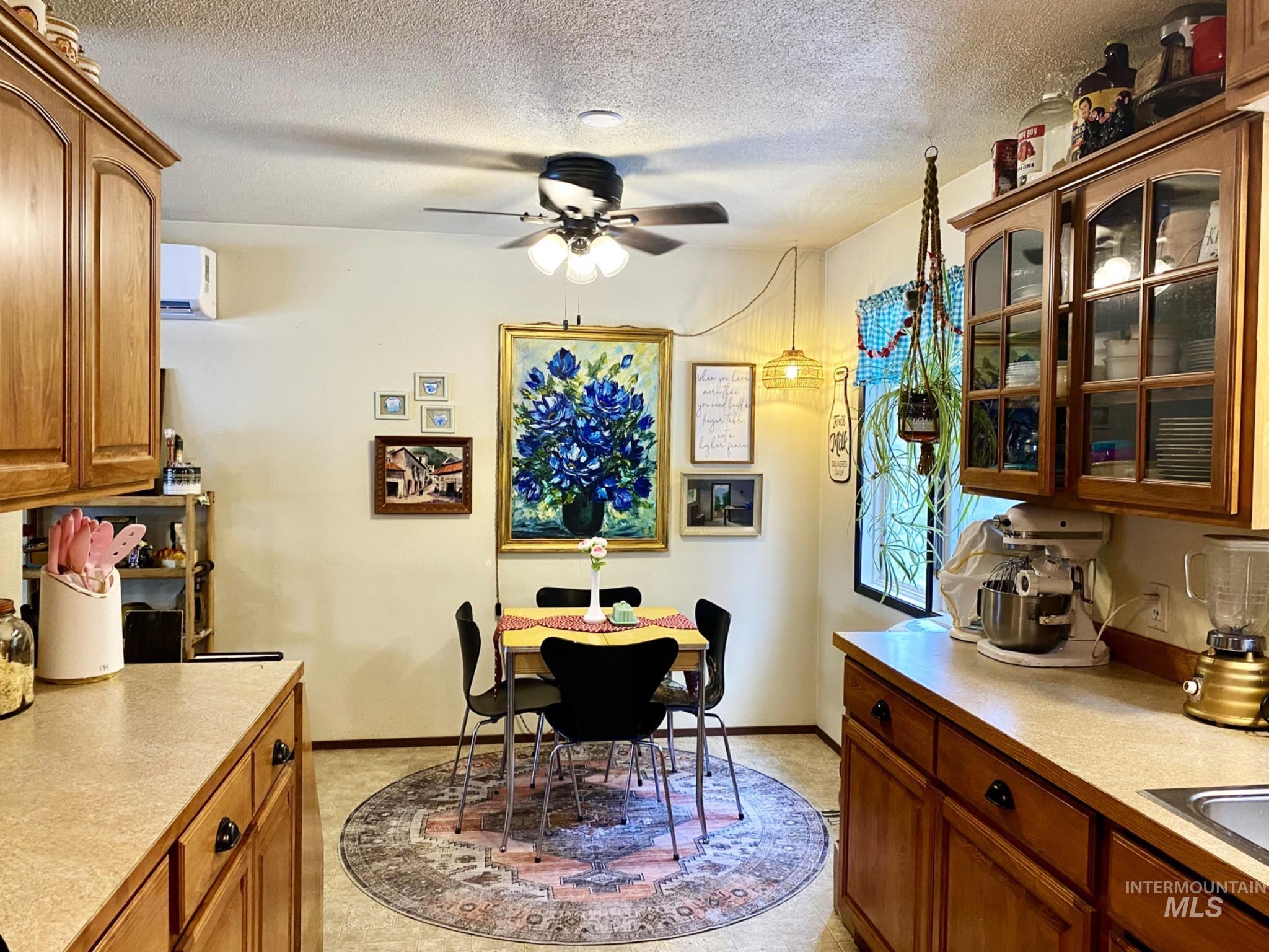 138 Timberline Drive Pierce, ID 83546 - Photo 9 of 28 Dining space with a textured ceiling, a wall mounted mini split, and ceiling fan