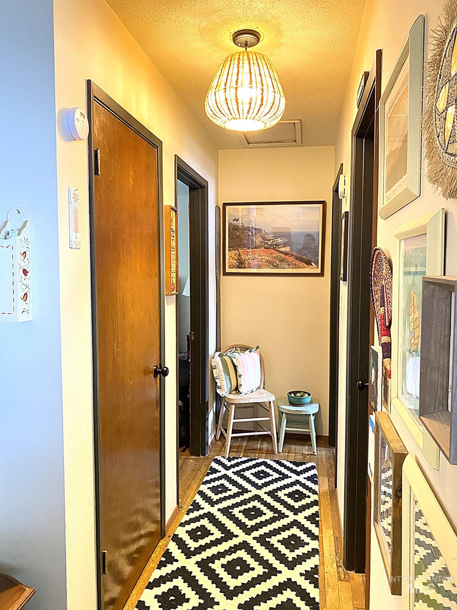 138 Timberline Drive Pierce, ID 83546 - Photo 10 of 28 Hall featuring a textured ceiling and light wood finished floors