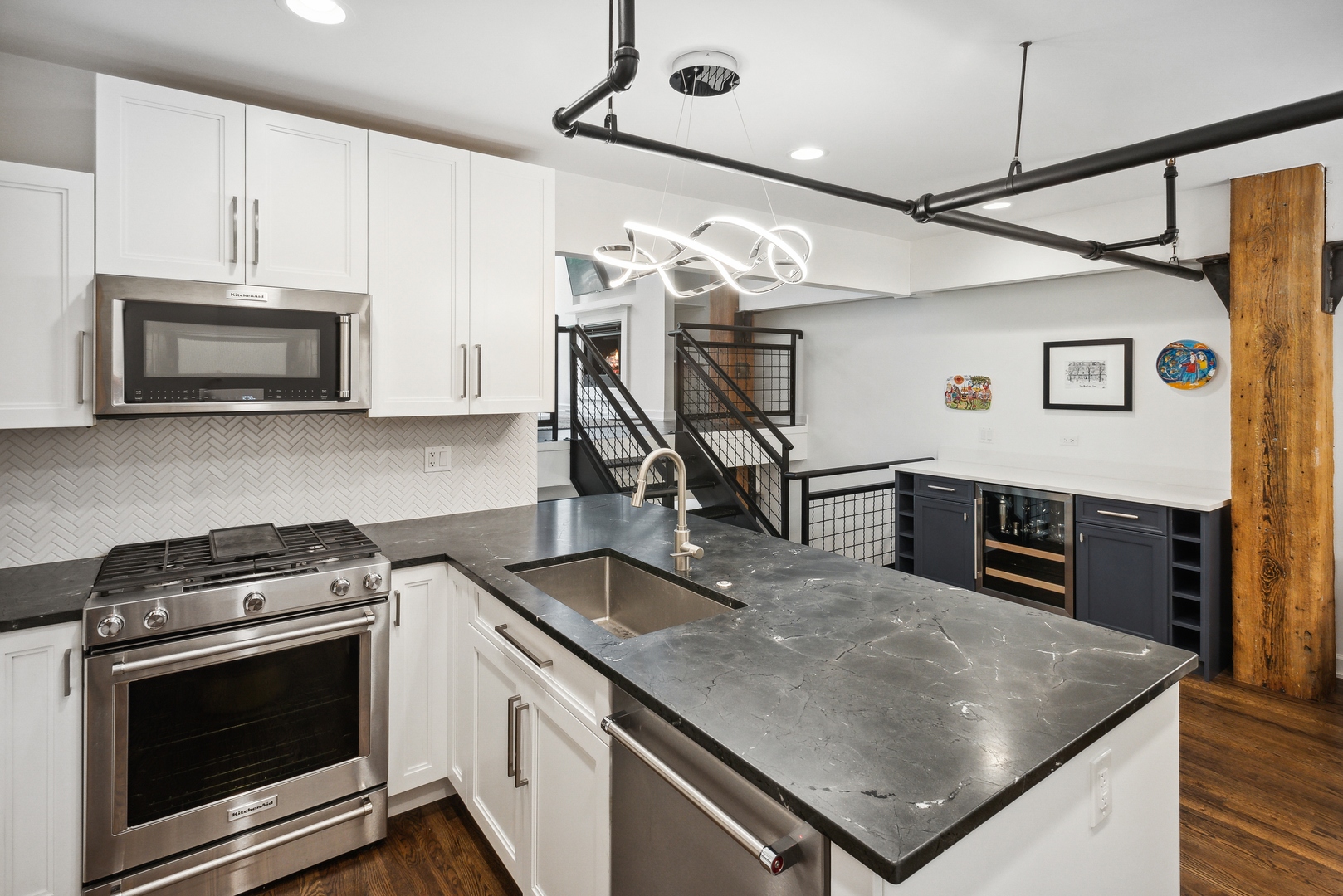 1000 West Washington Boulevard, Unit 148 Chicago, IL 60607 - Photo 11 of 18 a kitchen with stainless steel appliances granite countertop a stove cabinets and microwave