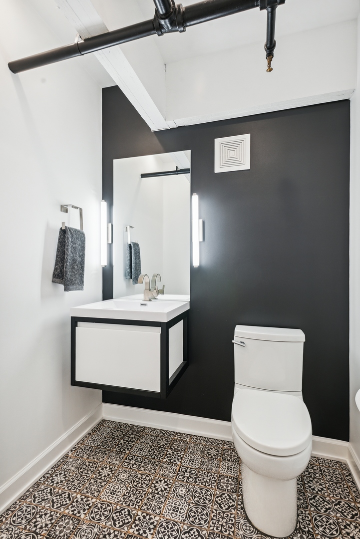 1000 West Washington Boulevard, Unit 148 Chicago, IL 60607 - Photo 12 of 18 a bathroom with a toilet a sink and mirror