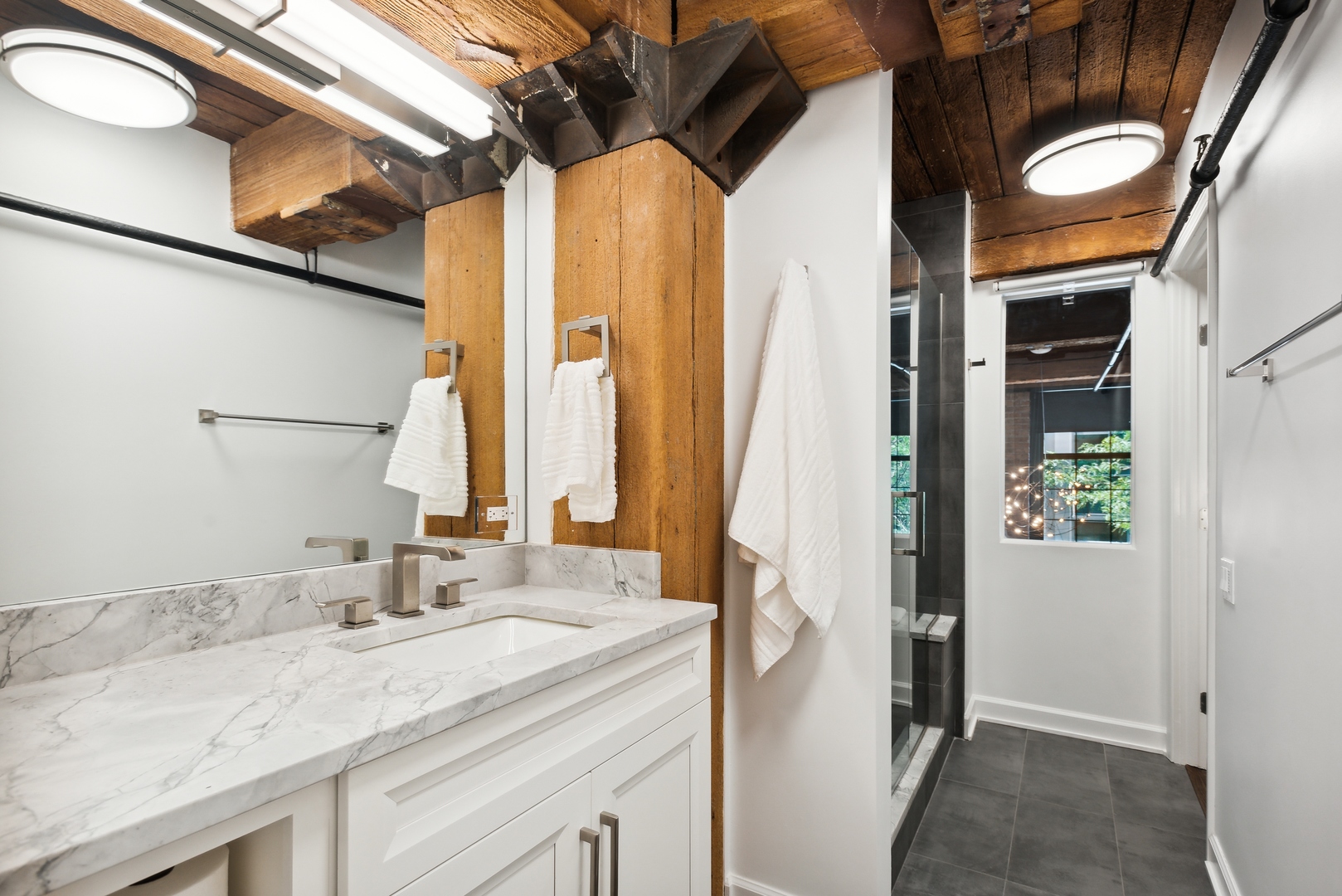 1000 West Washington Boulevard, Unit 148 Chicago, IL 60607 - Photo 15 of 18 a bathroom with a granite countertop sink and a mirror