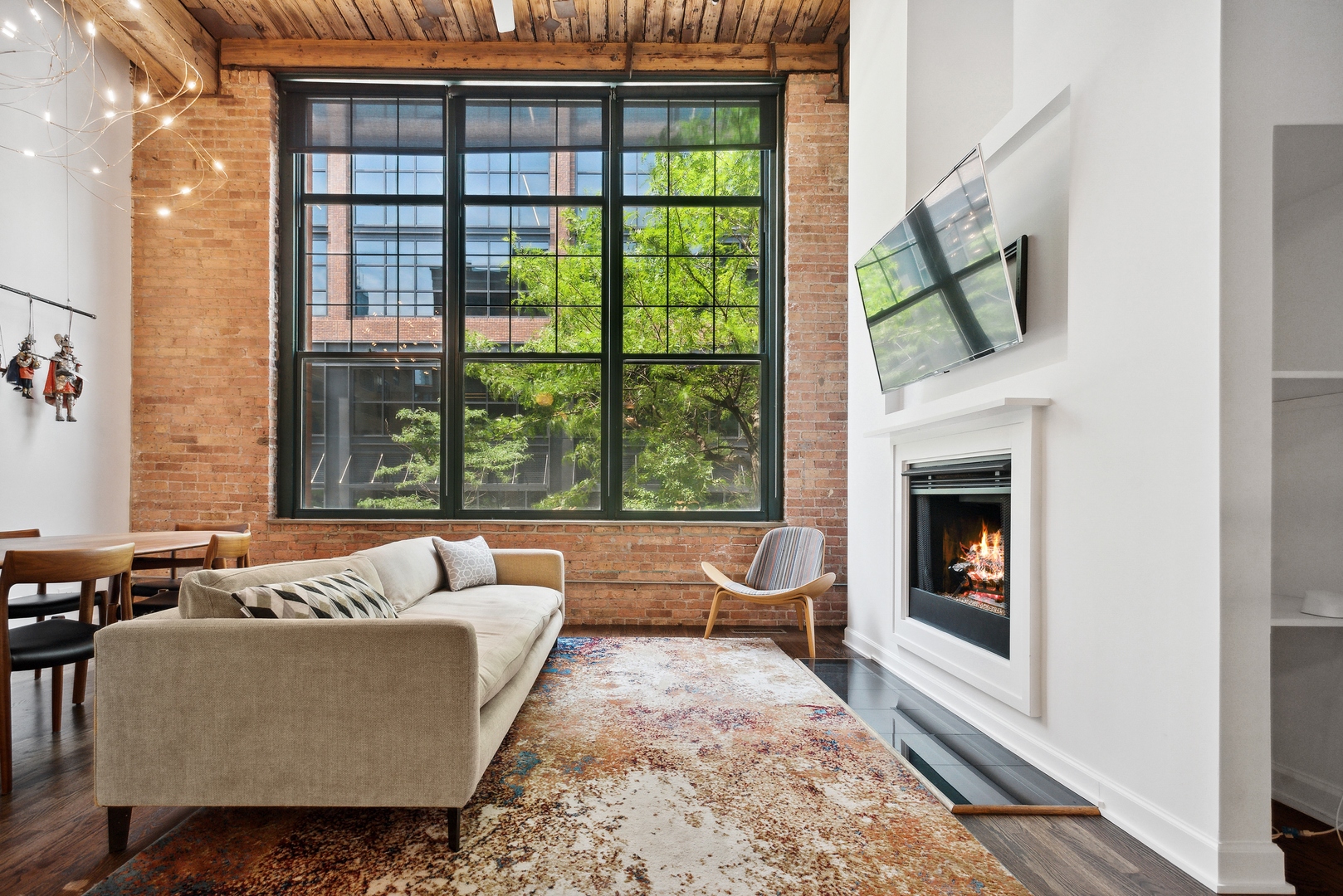 1000 West Washington Boulevard, Unit 148 Chicago, IL 60607 - Photo 2 of 18 a living room with furniture and a fireplace